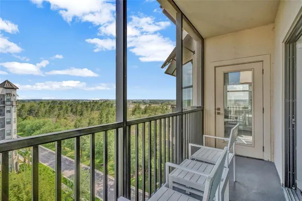 a view of a chair and tables in the balcony