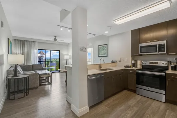a large kitchen with stainless steel appliances granite countertop a stove and a sink
