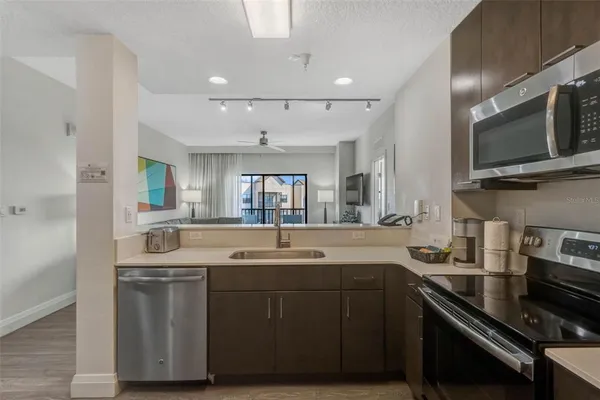 a kitchen with a sink stove and microwave