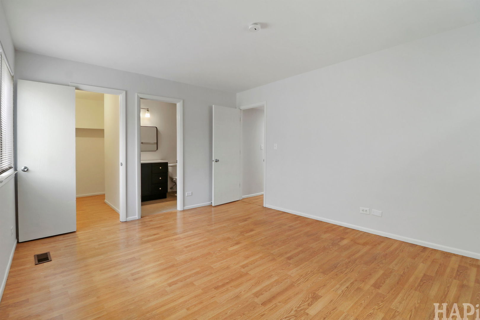 602 Eastview Court, Unit Z1 Schaumburg, IL 60194 - Photo 13 of 19 a view of an empty room with wooden floor and a bathroom