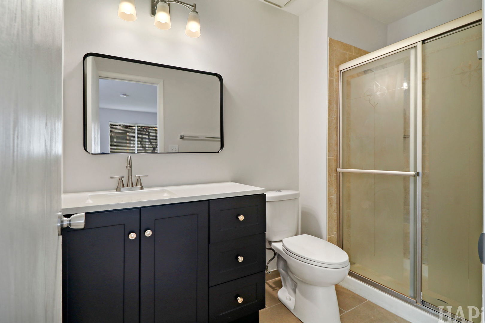 602 Eastview Court, Unit Z1 Schaumburg, IL 60194 - Photo 15 of 19 a bathroom with a toilet a sink a vanity and mirror