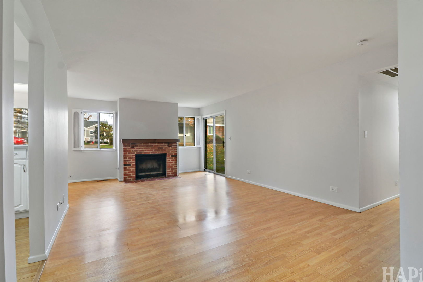 602 Eastview Court, Unit Z1 Schaumburg, IL 60194 - Photo 2 of 19 a view of an empty room with wooden floor fireplace and a window
