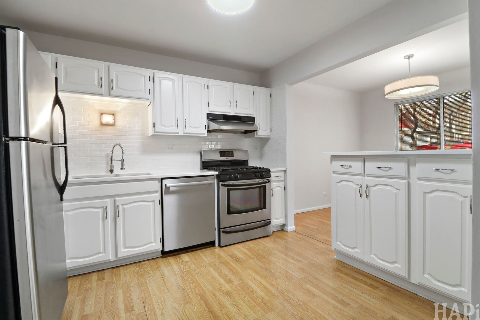 602 Eastview Court, Unit Z1 Schaumburg, IL 60194 - Photo 6 of 19 a kitchen with white cabinets and stainless steel appliances