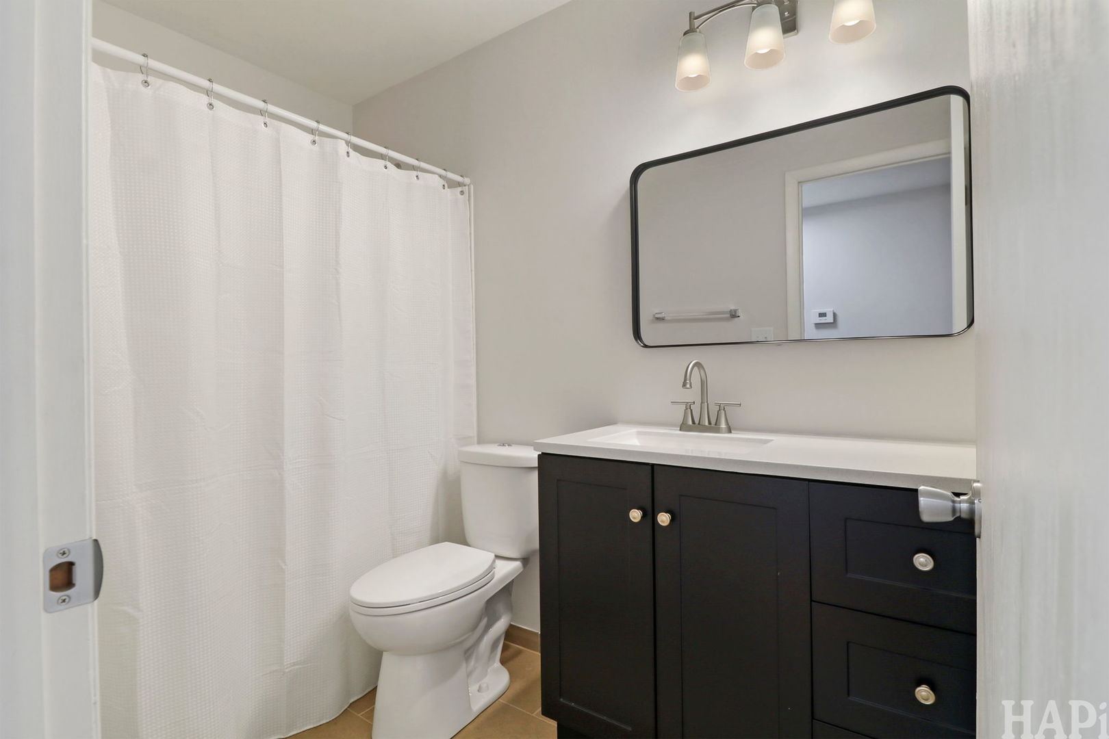 602 Eastview Court, Unit Z1 Schaumburg, IL 60194 - Photo 9 of 19 a bathroom with a toilet a sink a vanity and mirror