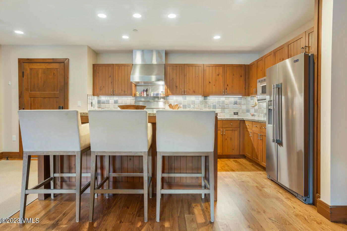 180 Daybreak Ridge Road, Unit 309 Avon, CO 81620 - Photo 15 of 27 a kitchen with kitchen island wooden cabinets and refrigerator