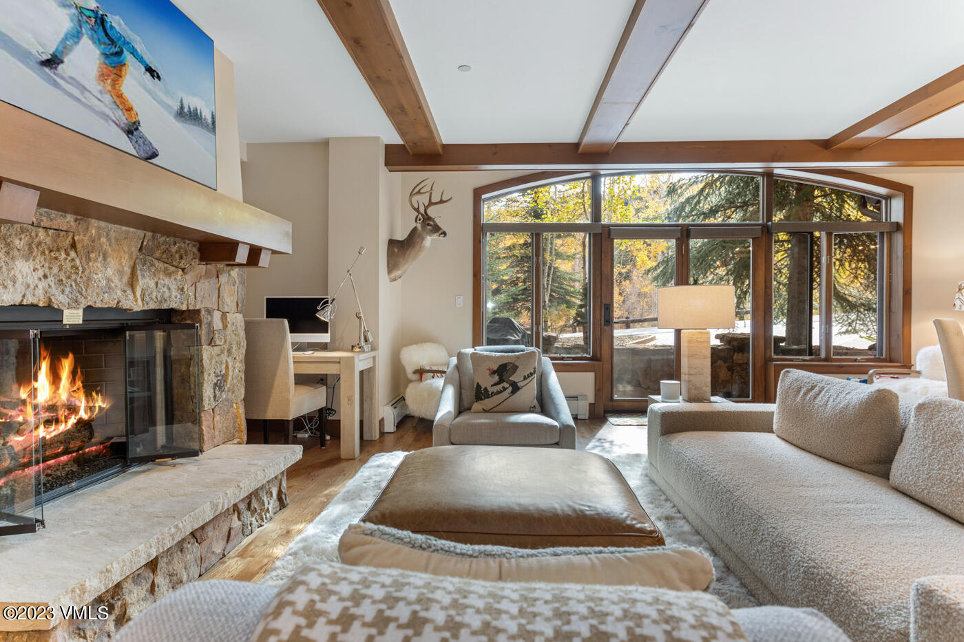 180 Daybreak Ridge Road, Unit 309 Avon, CO 81620 - Photo 3 of 27 a living room with furniture a flat screen tv and a fireplace