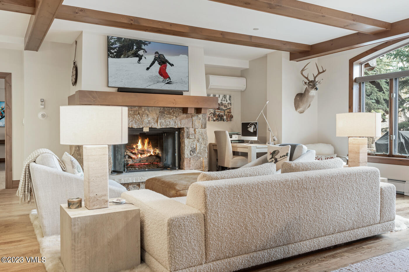 180 Daybreak Ridge Road, Unit 309 Avon, CO 81620 - Photo 4 of 27 a living room with furniture and a fireplace