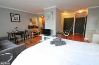 a living room with furniture a dining table and a flat screen tv