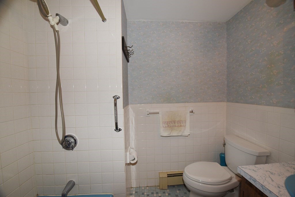 21 Whitehaven Way Dennis, MA 02660 - Photo 24 of 35 a bathroom with a granite countertop toilet a sink and shower