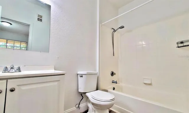 a kitchen with granite countertop cabinets stainless steel appliances and wooden floor