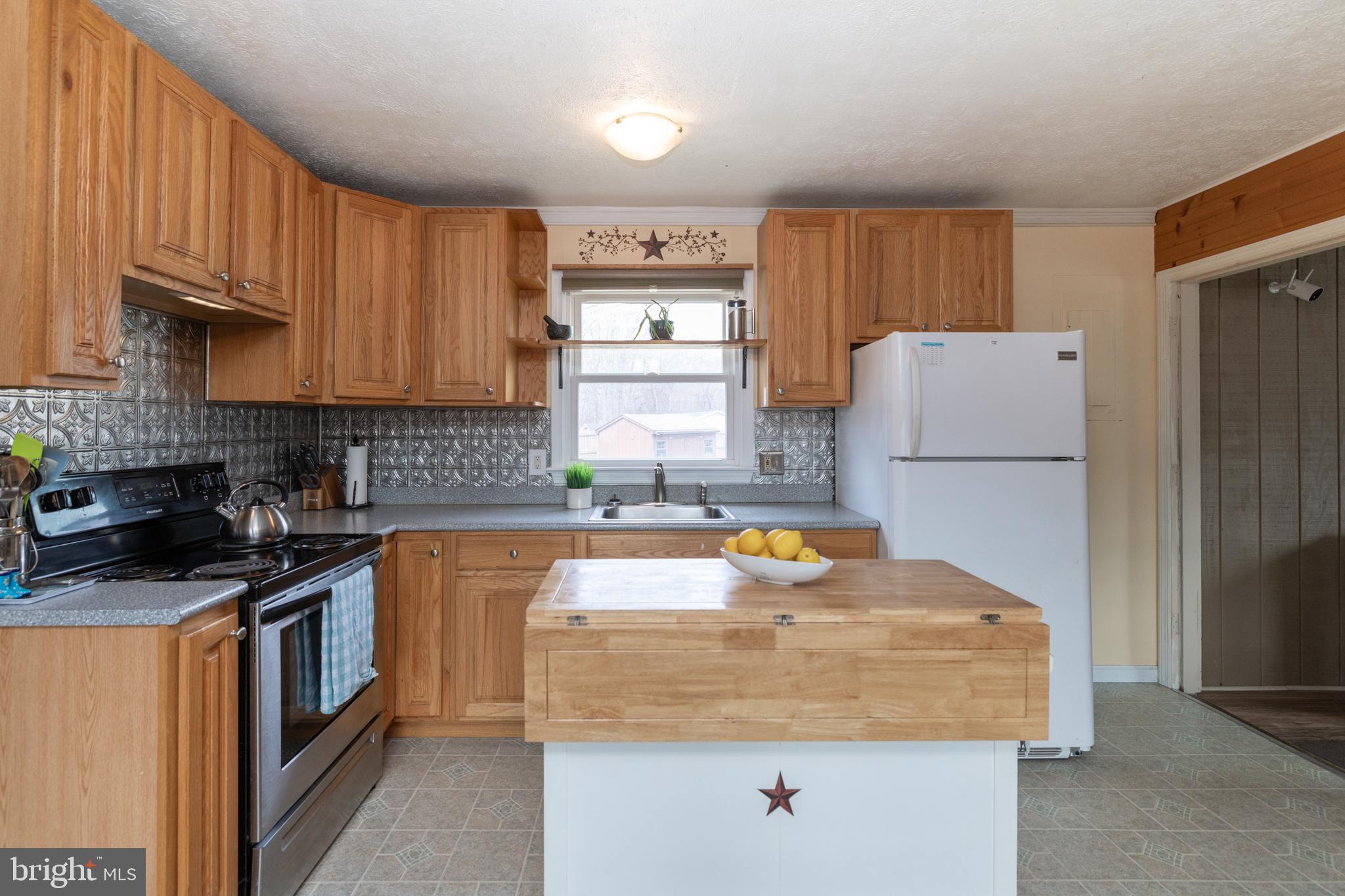 411 Mountain Lake Drive Front Royal, VA 22630 - Photo 14 of 38 a kitchen with a sink a stove and refrigerator