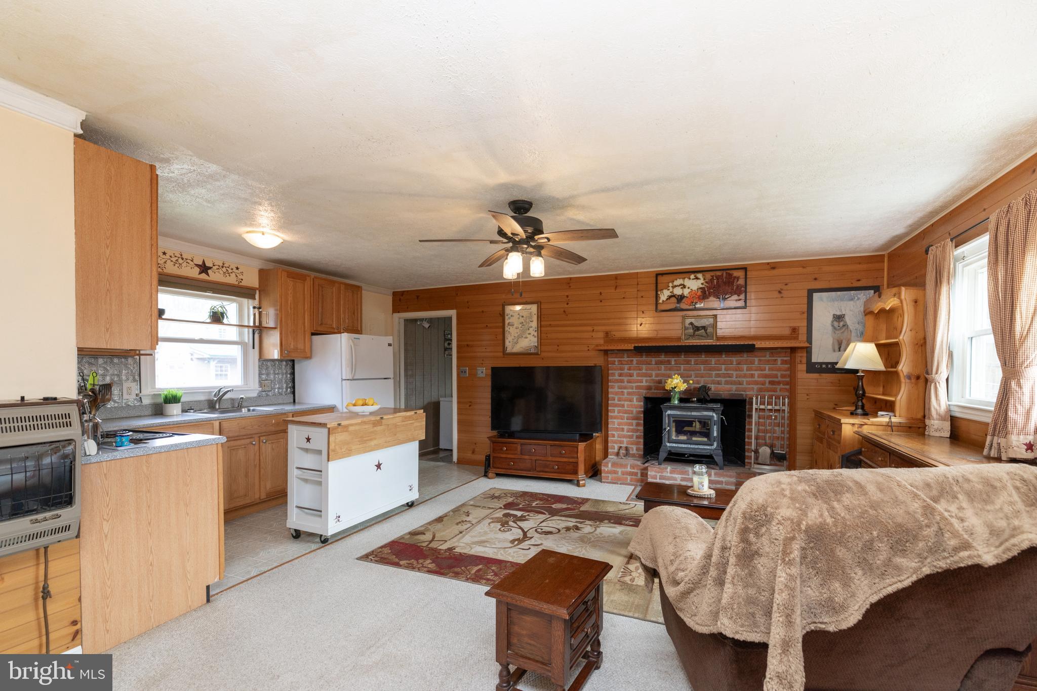 411 Mountain Lake Drive Front Royal, VA 22630 - Photo 16 of 38 a living room with furniture a fireplace and a flat screen tv