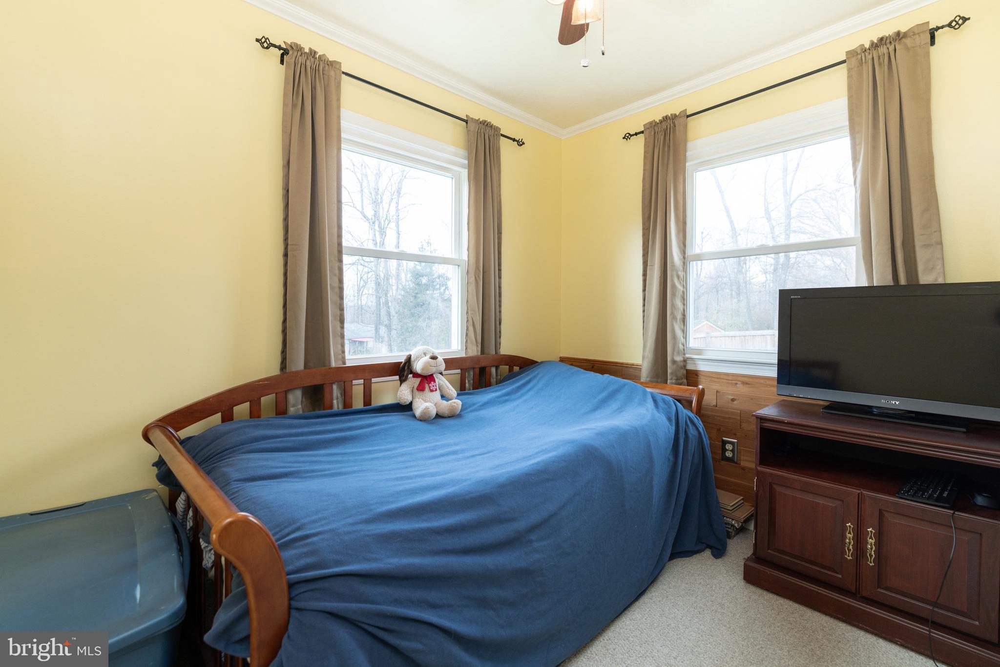 411 Mountain Lake Drive Front Royal, VA 22630 - Photo 22 of 38 a bedroom with a bed and a flat screen tv