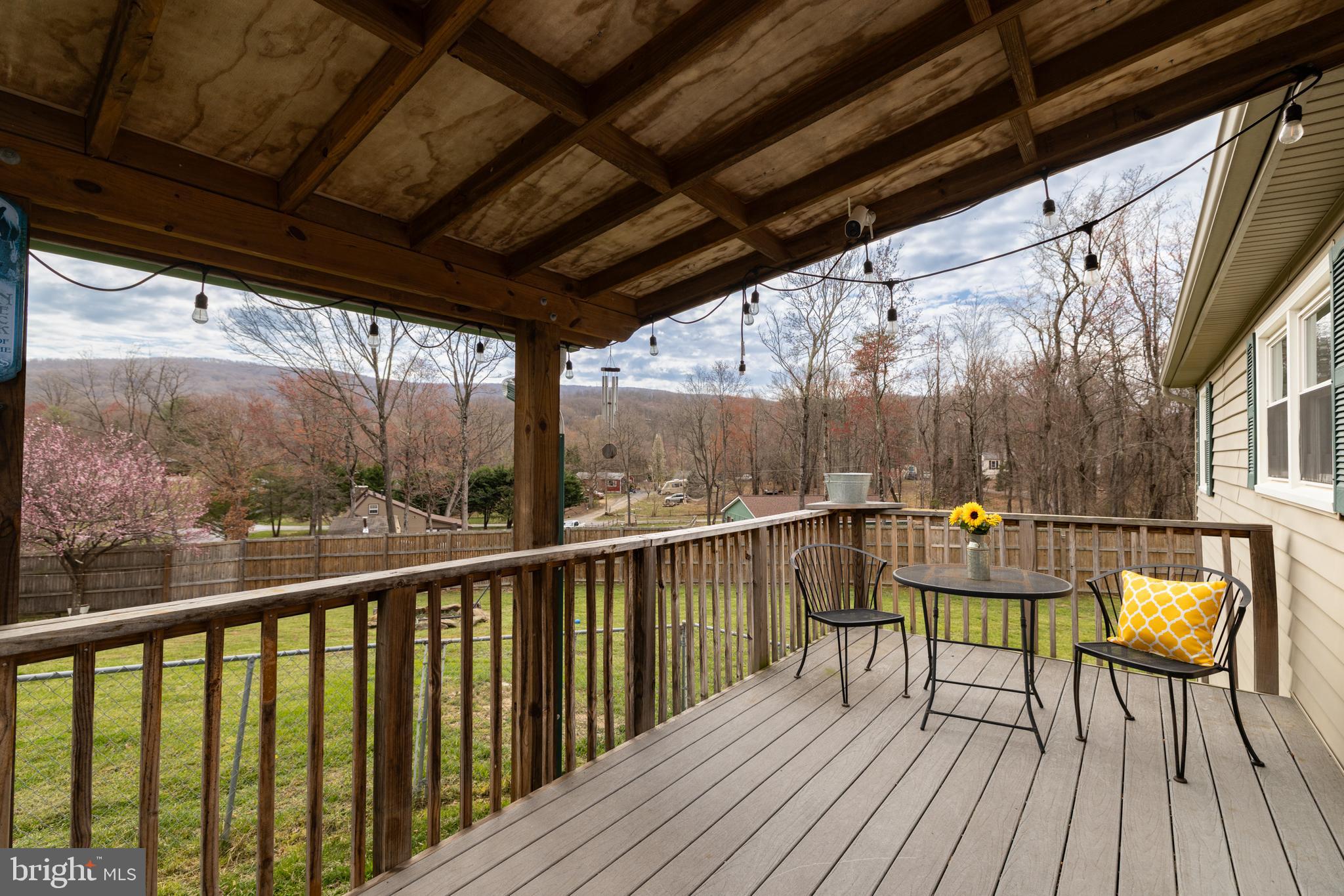 411 Mountain Lake Drive Front Royal, VA 22630 - Photo 9 of 38 a view of balcony with chairs and wooden fence