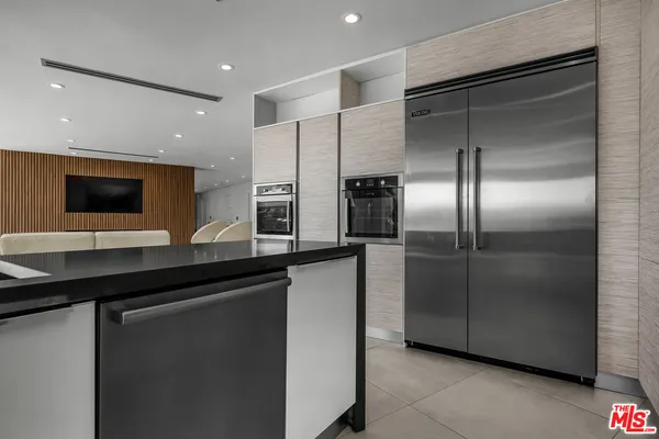 a kitchen with stainless steel appliances a refrigerator sink and stove