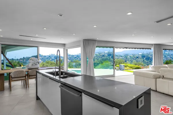 a view of a dining room with furniture large windows and wooden floor