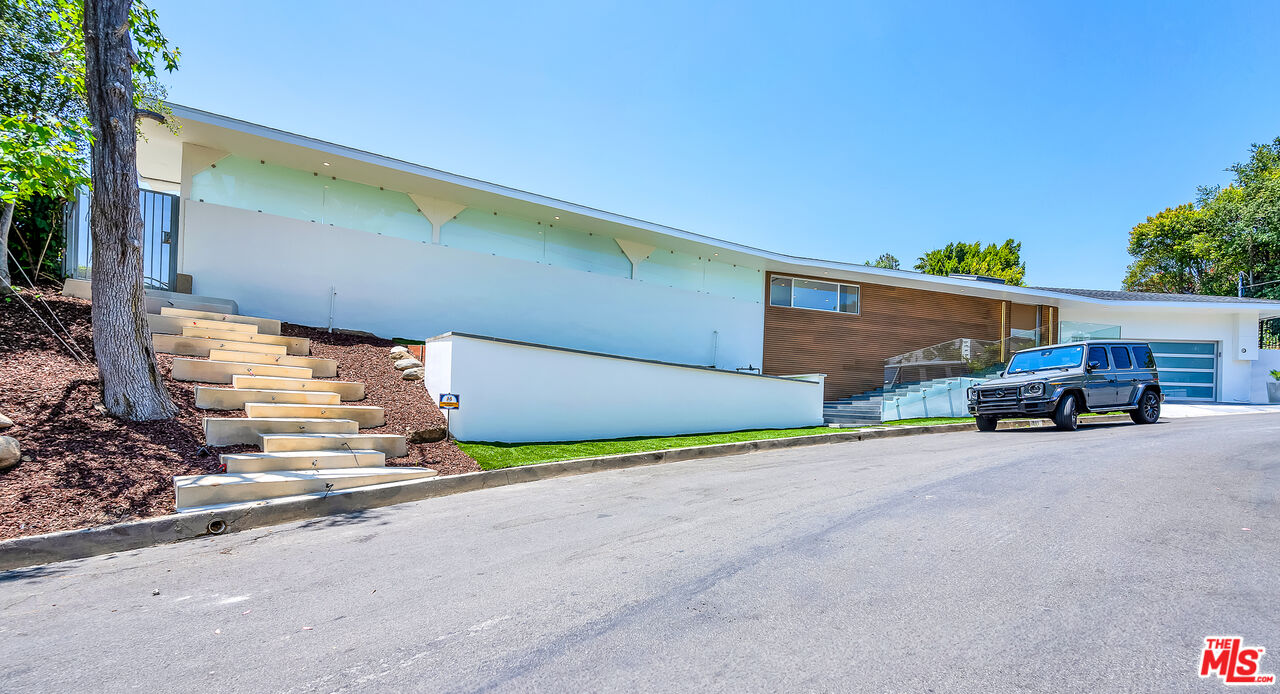 849 Glenmere Way Los Angeles, CA 90049 - Photo 2 of 40 a view of a house with a patio