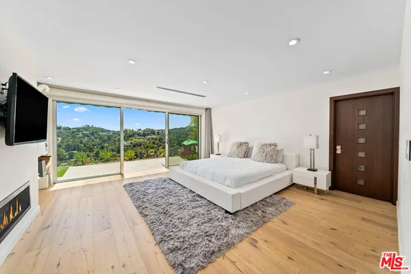 a spacious bedroom with a large bed and a dresser