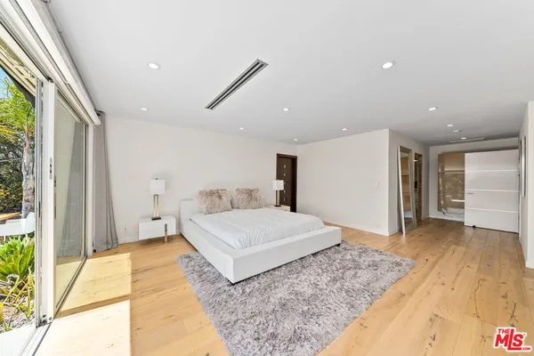 a bedroom with a large bed and a large window