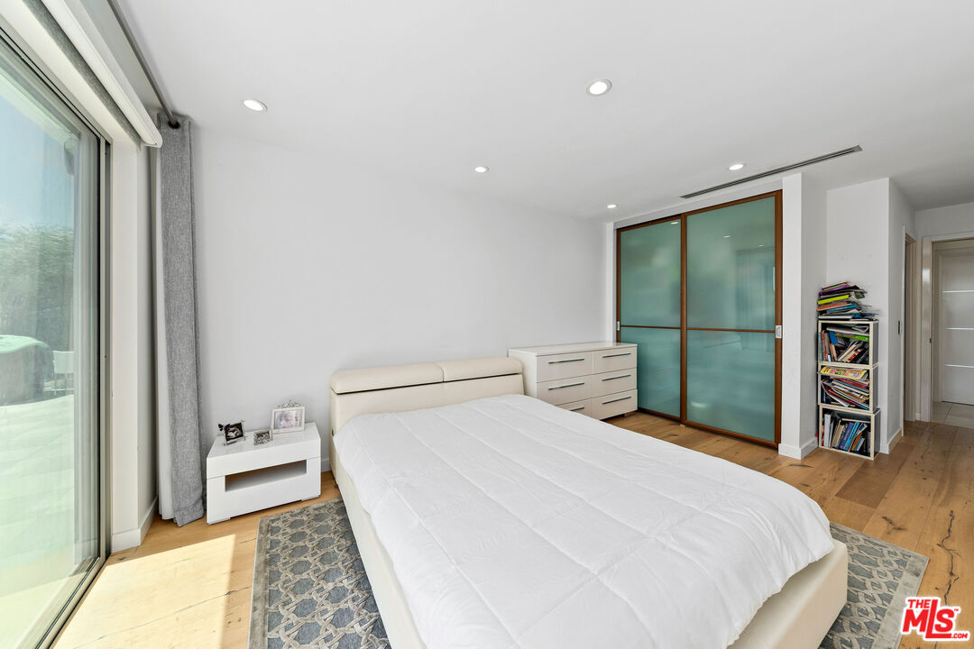849 Glenmere Way Los Angeles, CA 90049 - Photo 27 of 40 a bedroom with a bed and a walk in closet
