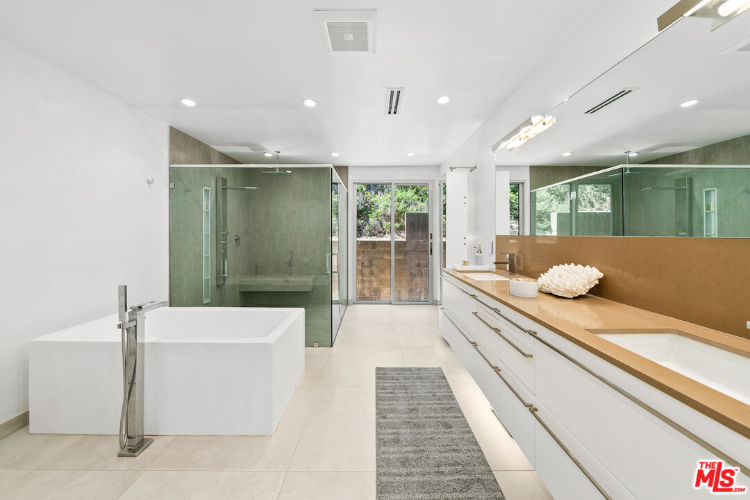 849 Glenmere Way Los Angeles, CA 90049 - Photo 28 of 40 a bathroom with a double vanity sink and mirror