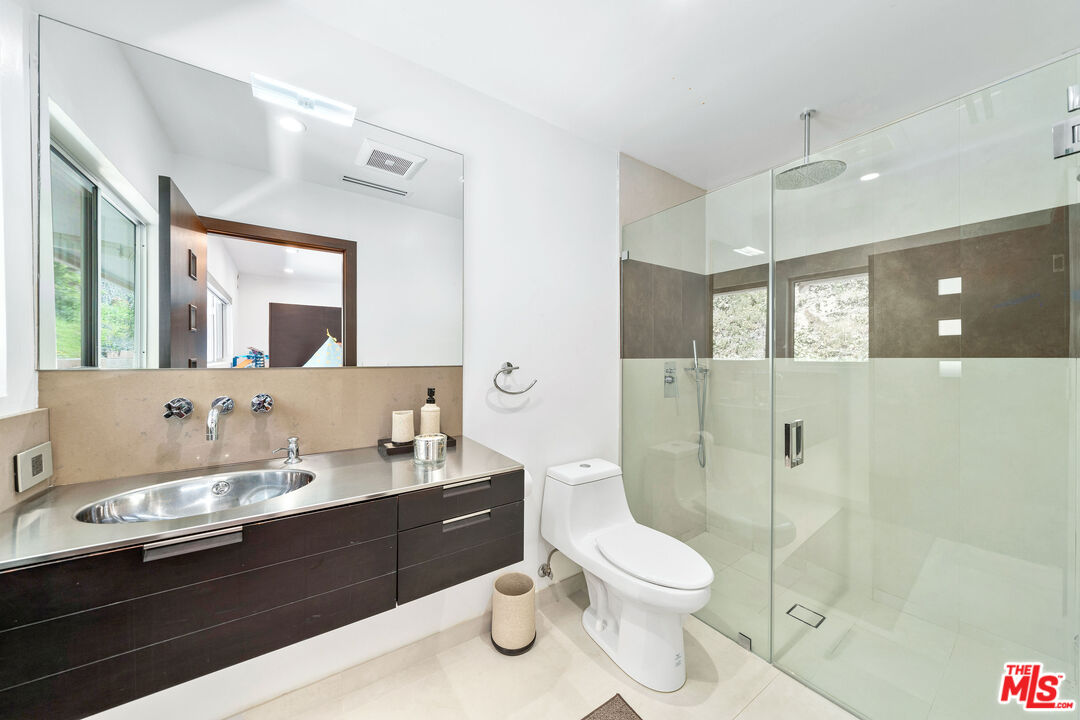 849 Glenmere Way Los Angeles, CA 90049 - Photo 30 of 40 a bathroom with a double vanity sink toilet and shower