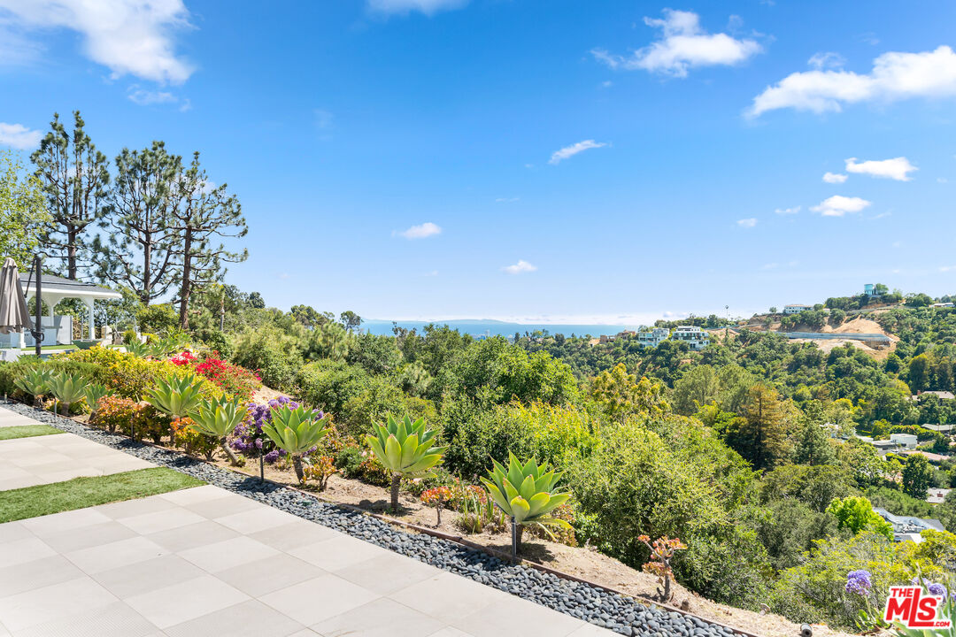 849 Glenmere Way Los Angeles, CA 90049 - Photo 31 of 40 a view of a garden with a building in background