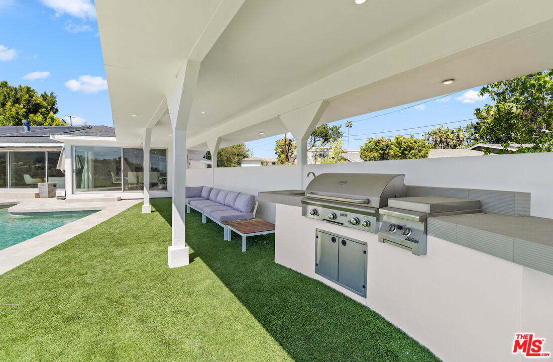849 Glenmere Way Los Angeles, CA 90049 - Photo 32 of 40 a front view of a house with garden and patio