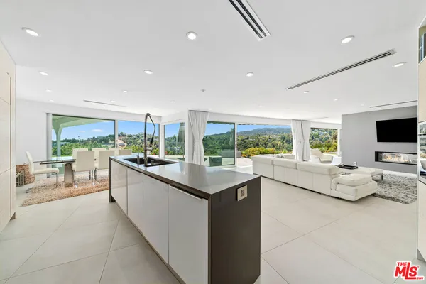 a large kitchen with stainless steel appliances kitchen island a large counter top