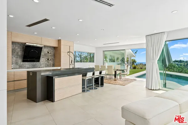 a kitchen with a sink and a stove top oven