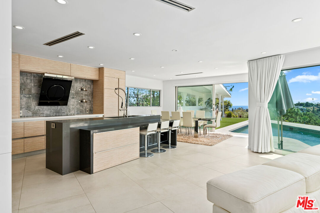 849 Glenmere Way Los Angeles, CA 90049 - Photo 39 of 40 a large kitchen with stainless steel appliances kitchen island a large counter top