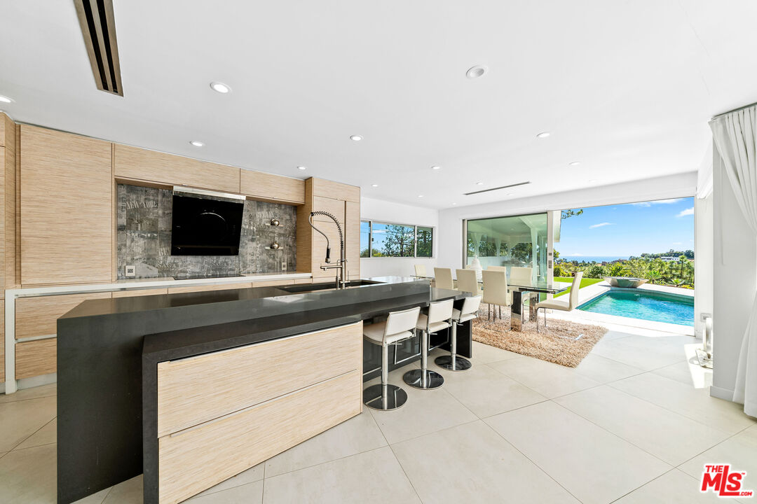 849 Glenmere Way Los Angeles, CA 90049 - Photo 40 of 40 a kitchen with a sink and a stove top oven