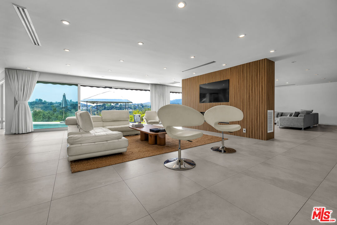 849 Glenmere Way Los Angeles, CA 90049 - Photo 5 of 40 a living room with furniture and a large window