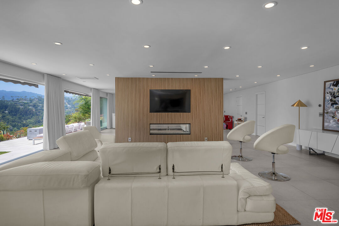 849 Glenmere Way Los Angeles, CA 90049 - Photo 9 of 40 a living room with furniture and a large window