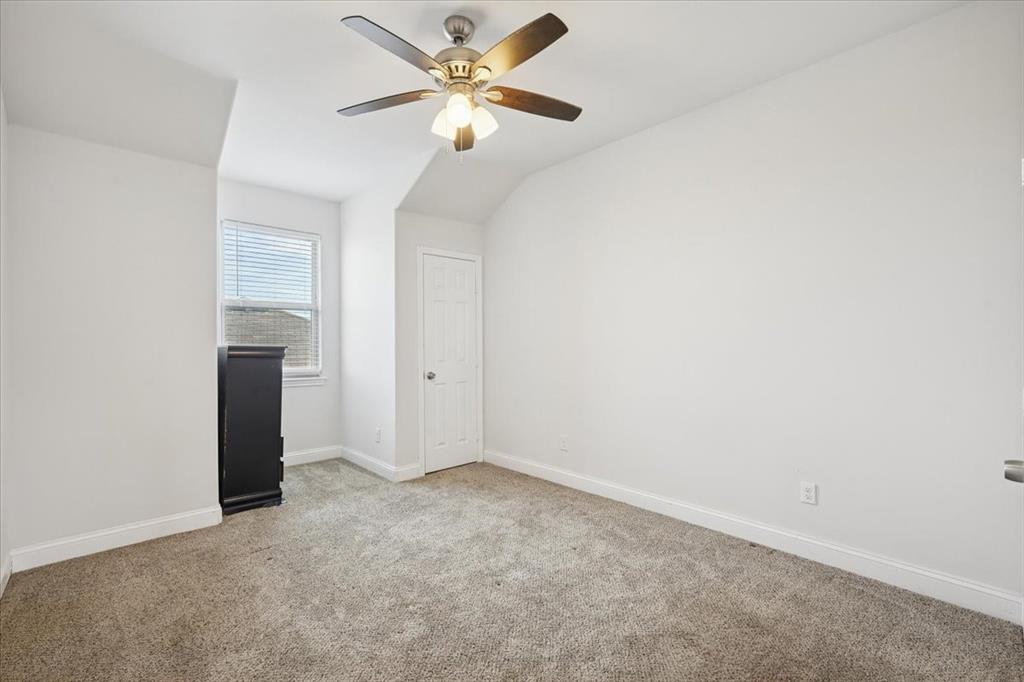 313 Marble Creek Drive Fort Worth, TX 76131 - Photo 12 of 27 an empty room with a ceiling fan and a window