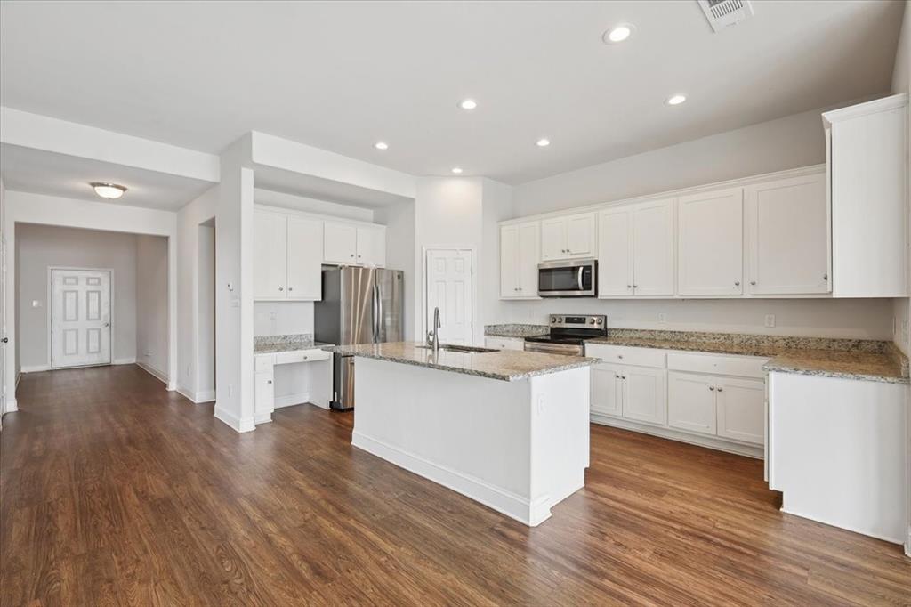 313 Marble Creek Drive Fort Worth, TX 76131 - Photo 13 of 27 a kitchen with stainless steel appliances granite countertop a stove top oven a sink and a refrigerator