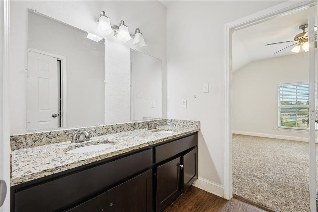 313 Marble Creek Drive Fort Worth, TX 76131 - Photo 14 of 27 a bathroom with a granite countertop sink and a mirror