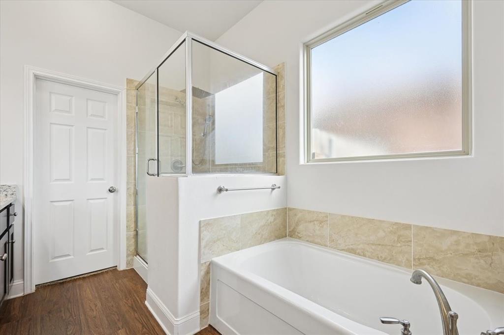 313 Marble Creek Drive Fort Worth, TX 76131 - Photo 19 of 27 a bathroom with a bathtub and a shower