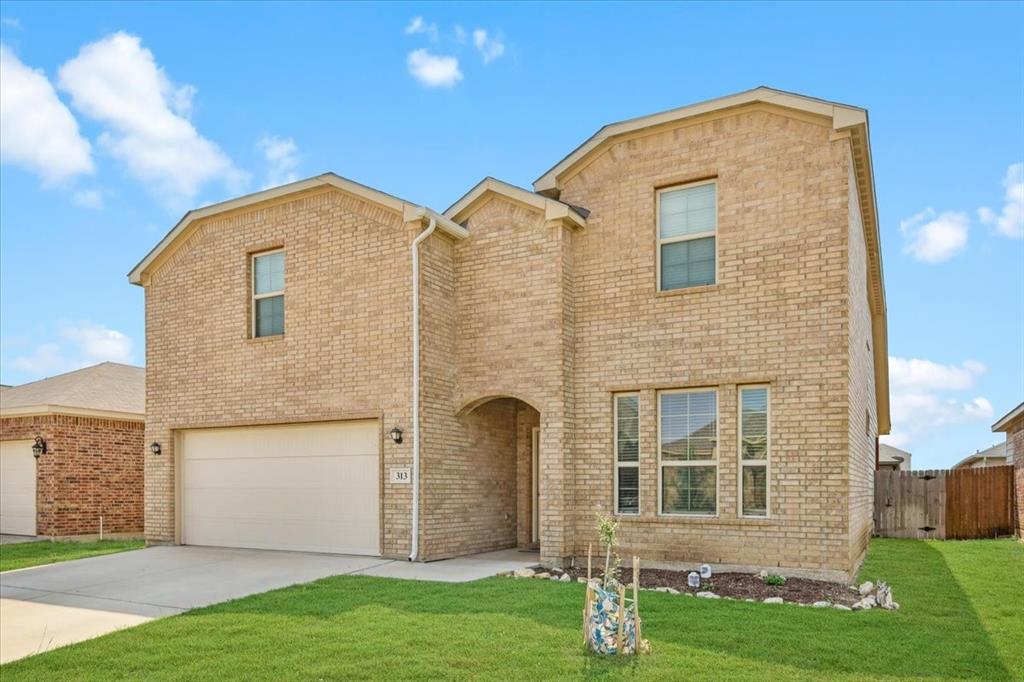 313 Marble Creek Drive Fort Worth, TX 76131 - Photo 2 of 27 a front view of a house with garden