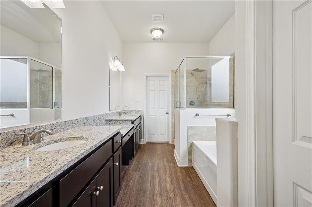 313 Marble Creek Drive Fort Worth, TX 76131 - Photo 20 of 27 a bathroom with a granite countertop sink a mirror and a shower