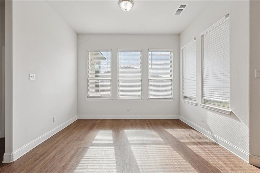 313 Marble Creek Drive Fort Worth, TX 76131 - Photo 22 of 27 a view of empty room with wooden floor and fan