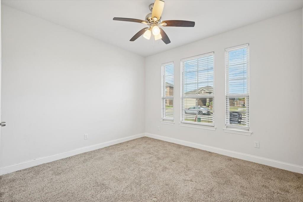 313 Marble Creek Drive Fort Worth, TX 76131 - Photo 23 of 27 an empty room with windows and fan