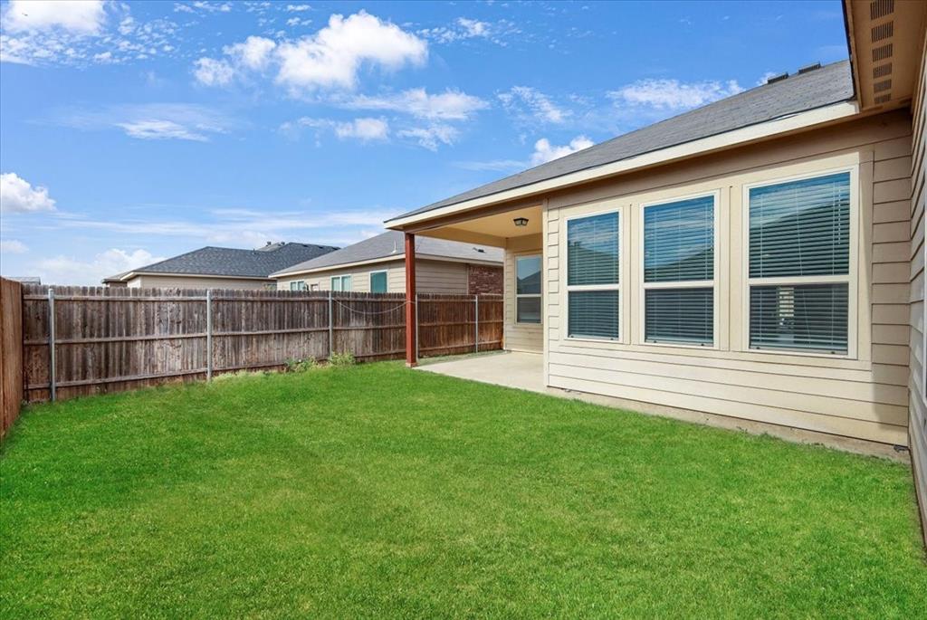 313 Marble Creek Drive Fort Worth, TX 76131 - Photo 24 of 27 a view of a backyard with floor to ceiling window plants and trees