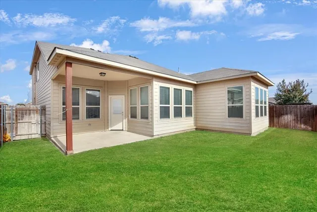 a view of a backyard with floor to ceiling window plants and trees