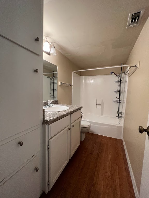 1000 West 26th Street, Unit 101 Austin, TX 78705 - Photo 9 of 10 Full bathroom with wood finished floors, vanity, shower combination, toilet, and visible vents