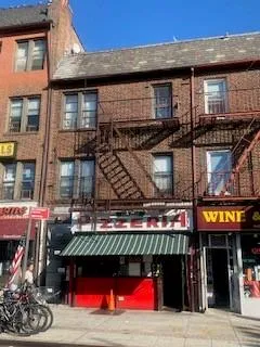 a building with retail shops and traffic signal