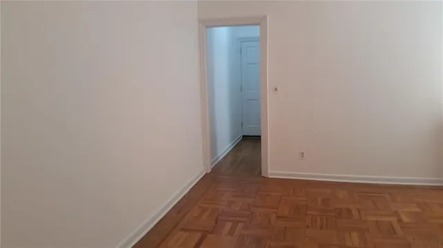 a view of hallway with wooden floor