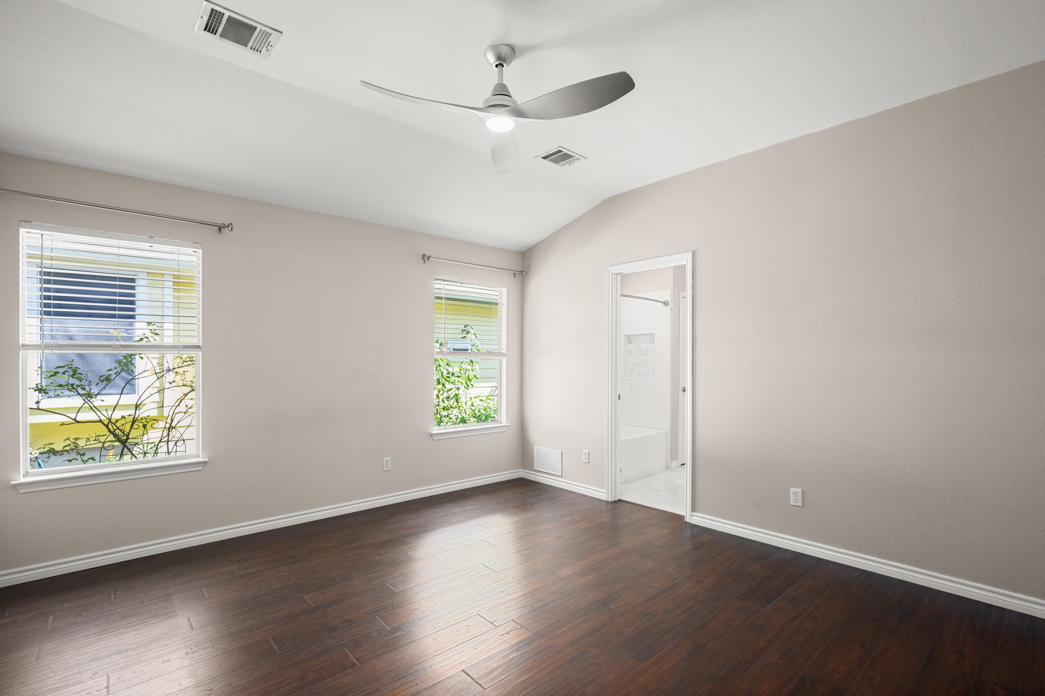 151 Sampson Kyle, TX 78640 - Photo 8 of 23 The primary suite offers a quieter retreat tucked toward the back of the home for additional privacy and separation from the secondary bedrooms.