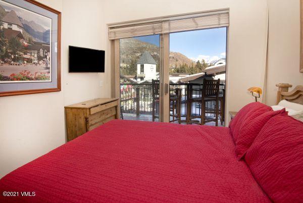 225 Wall Street, Unit 302 Vail, CO 81657 - Photo 12 of 19 a bedroom with a bed and glass window
