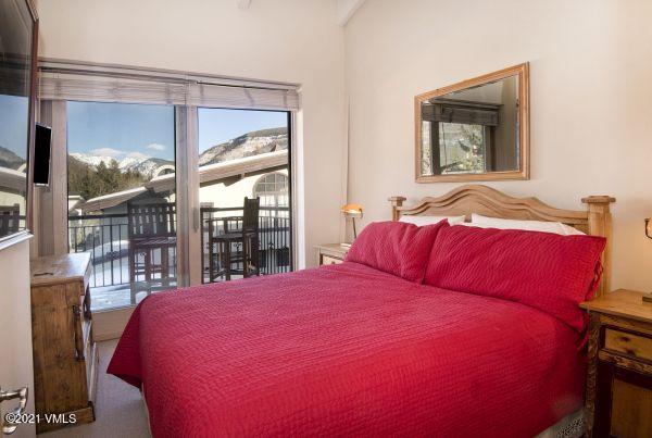 225 Wall Street, Unit 302 Vail, CO 81657 - Photo 13 of 19 a bedroom with a large bed and a window